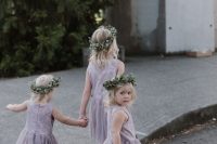 lavender midi flower girl dresses with lace bodices and pleated skirts, greenery crowns and flat shoes