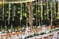 lights over the reception and hanging down in verticals make the reception look very festive and very romantic