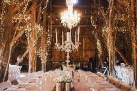 lit up trees and crystal chandeliers create a whimsical winter wonderland feel in the space