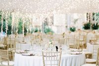 lots of lights hanging down to the reception bring more light and create a magical ambience in the space