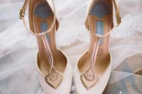 vintage-inspired blush and metallic wedding shoes with cutout hearts and T straps for a soft feel