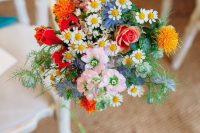 wedding aisle decor with blush, blue, neutral, red and orange blooms and greenery is amazing for a colorful wedding