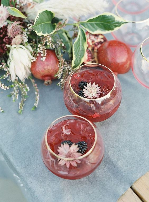 upgrade your signature cocktail with a red-colored base, blackberries, and a very favorite, edible flowers