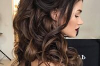 a beautiful half updo with a bump on top, a top ponytail, waves and curls down and locks framing the face is a very cute and sexy idea