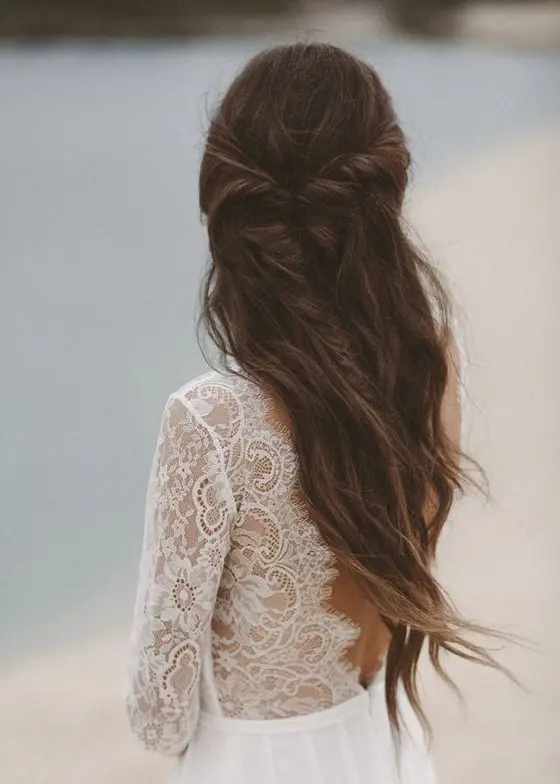a beautiful half updo with a messy twisted braid and waves down will effortlessly finish off your bridal look