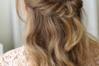 a beautiful looped half updo with waves down and face-framing locks is a cool idea for many brida styles