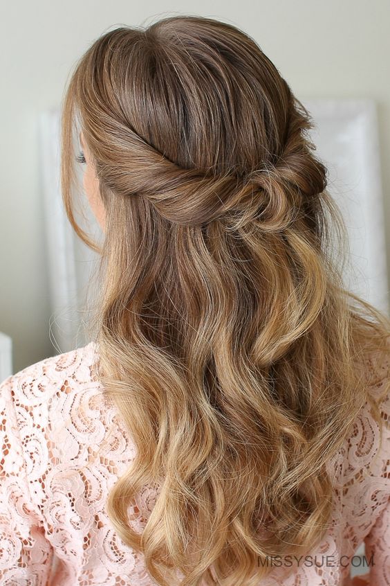 a beautiful looped half updo with waves down and face framing locks is a cool idea for many brida styles