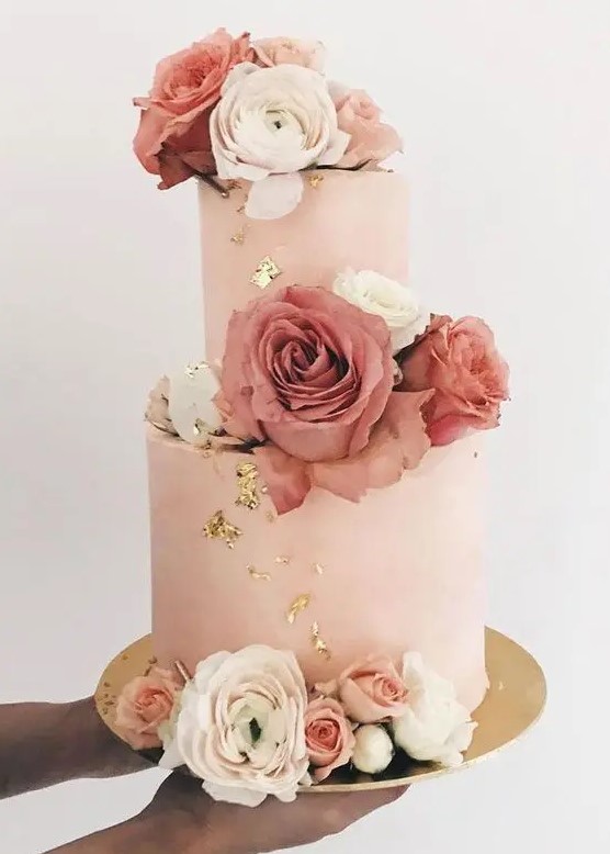 a blush buttercream wedding cake with gold foil, with white, pink and mauve roses is a fantastic idea for a glam wedding
