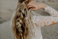 a boho half updo with braids and twists, with a large bubble braid and waves down is a beautiful and eye-catchy option