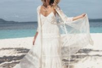 a boho lace spaghetti strap wedding gown with a matching coverup and a hat