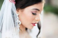 a bold floral and succulent crown and a veil is a bold and chic accessory for a beautiful bridal look