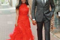 a bold hot red A-line wedding dress with a draped bodice and a layered skirt with a train plus a high neckline for a wedding with lots of color or to make a statement
