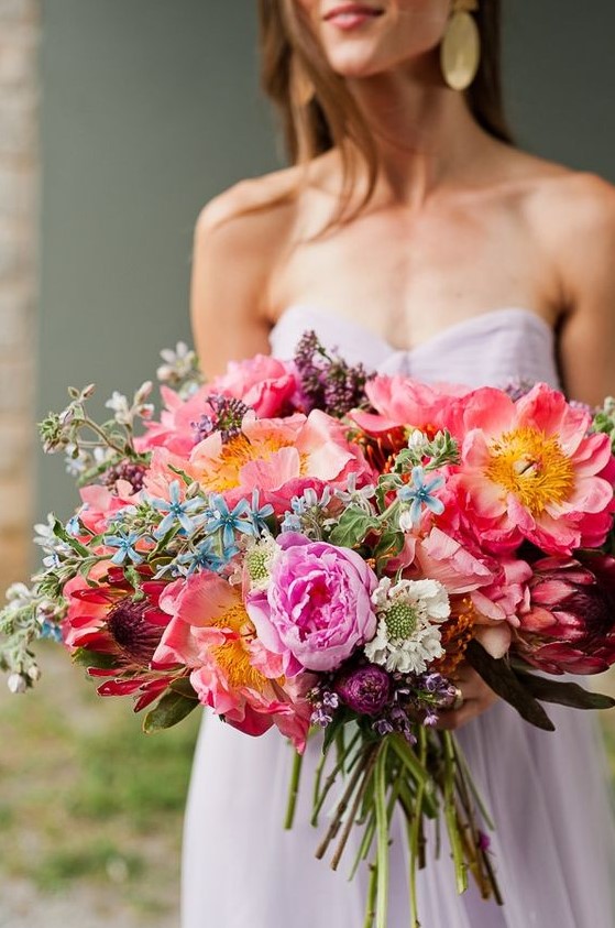 a bold wedding bouquet with pink, purple and blue blooms is a beautiful and cool idea for a summer wedding