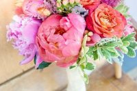 a bold wedding bouquet with pink, purple, red and yellow blooms, berries, foliage is a lovely idea for a summer wedding