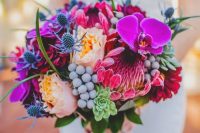 a bright wedding bouquet with hot pink, pink, blush blooms, berries, succulents and thistles is a cool idea