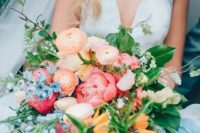 a bright wedding bouquet with pink, orange, yellow, blue and blush blooms, greenery and texture and dimension is amazing for summer