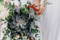 a cascading wedding bouquet of a large succulents, cascading greenery and small blooms is bold