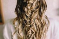 a chic wedding half updo with a large braid, with waves down and a gold leaf hair vine for a boho bride