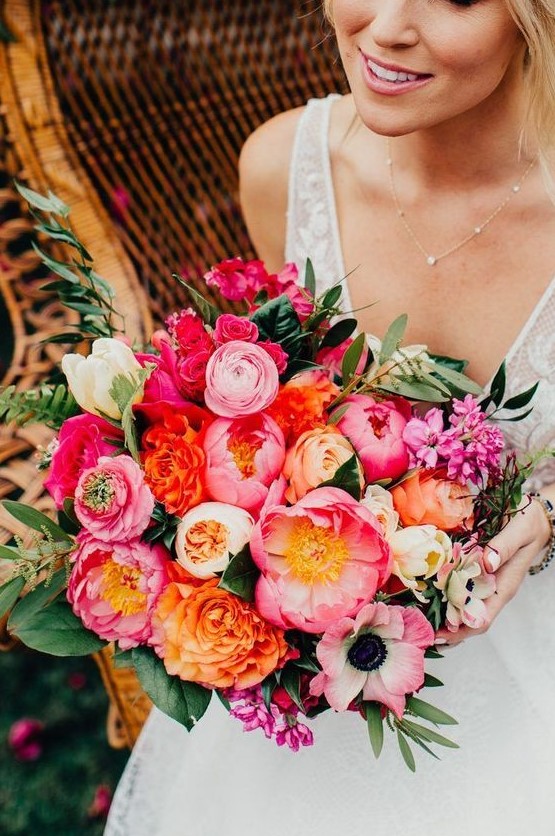a classy wedding bouquet with pink, orange, light pink and white blooms and greenery for a bright wedding