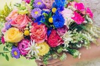 a colorful wedding bouquet with electric blue, yellow, pink, hot pink, purple blooms, astilbe, greenery is amazing