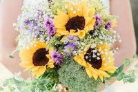 a colorful wedding bouquet with sunflowers, purple blooms, greenery, baby’s breath is a lovely idea for a rustic summer bride