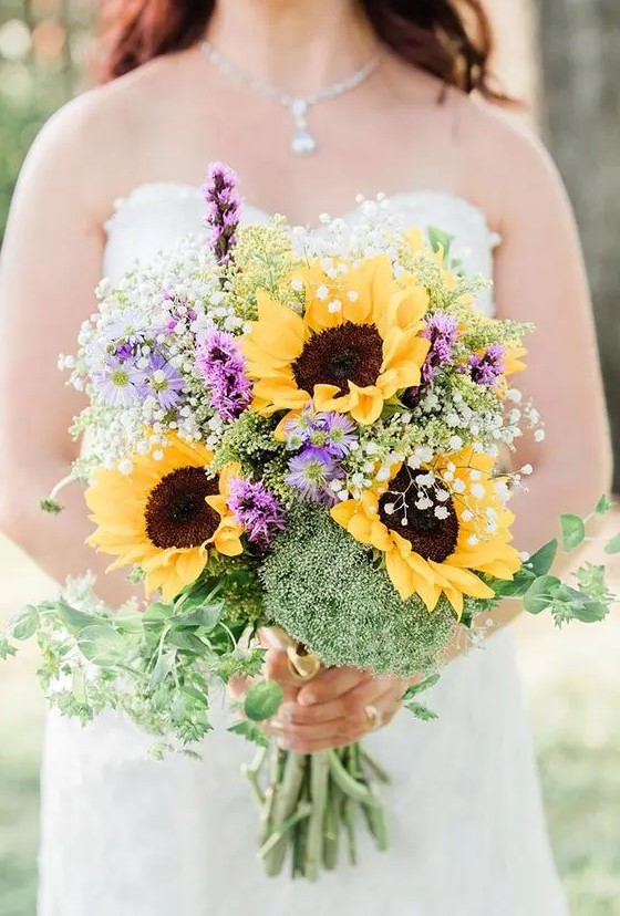 a colorful wedding bouquet with sunflowers, purple blooms, greenery, baby's breath is a lovely idea for a rustic summer bride