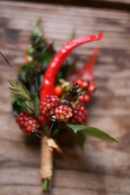 a cool berry and hot pepper boutonniere with greenery and with a twine wrap is a fun and cool idea for summer