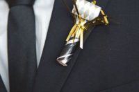 a cool black, white and gold Cracker wedding boutonniere is ideal for a NYE wedding