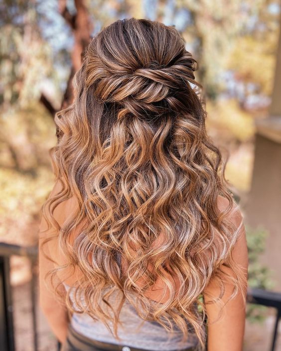 a cool boho wedding half updo with a twisted elements and waves down is a cool boho or rustic wedding hairstyle