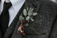 a cool winter wedding boutonniere of berries and pale leaves with a twine wrap is ideal for a Christmas wedding, too