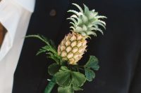 a creative wedding boutonniere of a mini pineapple with greenery is a perfect idea for a tropical wedding or for a glam summer one
