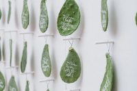 a creative wedding escort cards display with cards made of cacti for a desert wedding