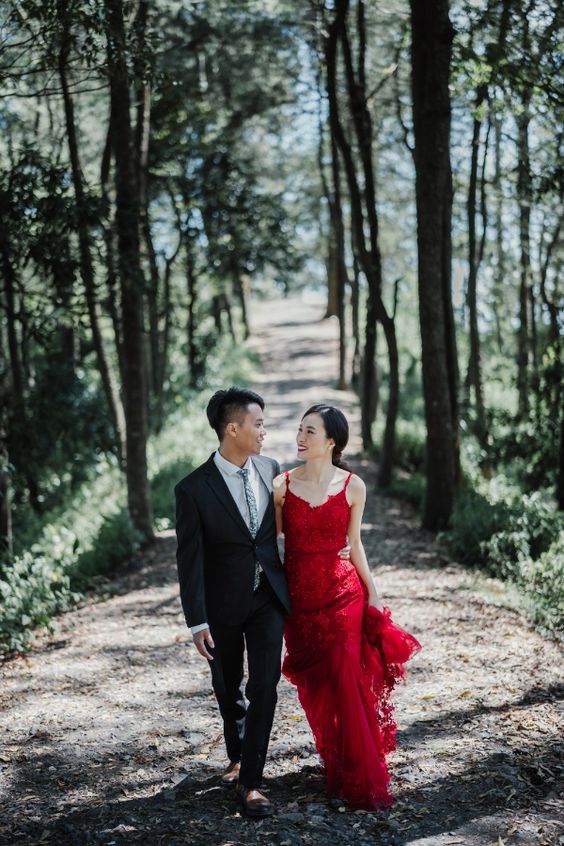 a deep red lace A-line wedding dress with spaghetti straps and a train is a gorgeous idea for a summer or a fall wedding