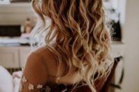 a delicate and lovely boho wedding half updo with a fishtail braid halo and waves down is ideal for a boho bride