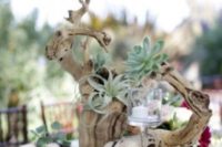 a driftwood wedding centerpiece with air plants, candles is a laconic and chic beach idea