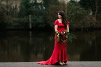 a fantastic A-line red wedding dress with a square neckline, short sleeves and a beautiful high low skirt wiht a train plus silver shoes for a bold fall wedding