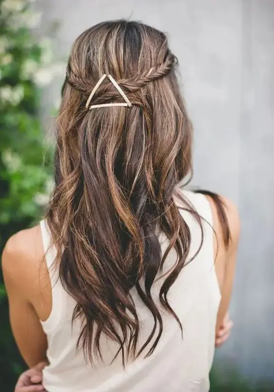 a fishtail braided half updo with waves and an eye-catchy geometric hairpiece that adds a boho feel