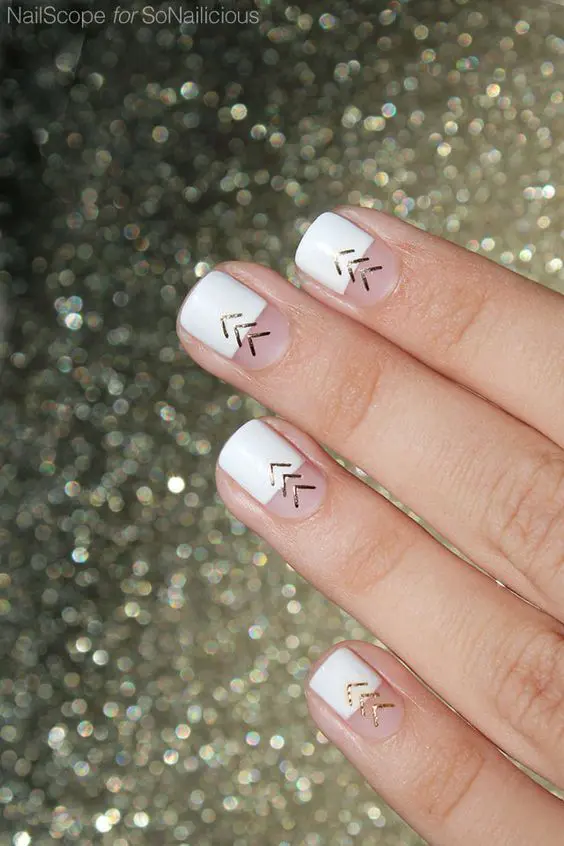 a fresh take on a French manicure - color block with gold chevrons is a cool and bold option to rock