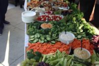 a fresh veggie and fruit salad bar with various kinds of dressing is a great idea that works for any wedding