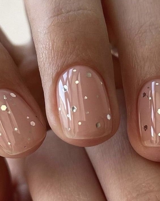 a glossy nude wedding manicure with gold polka dots of various sizes is a lovely and chic idea for a glam bride