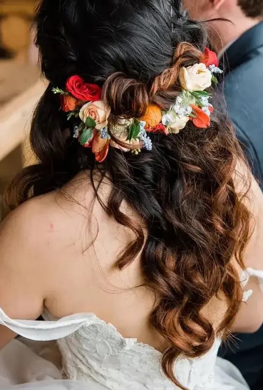 a half updo on long hair, with braids and waves down, with super bright blooms and greenery for a bold fall wedding
