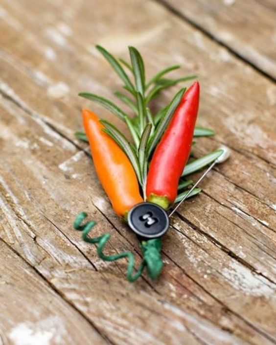 a hot pepper and greenery plus a button boutonniere with a pin is a lovely idea for a rustic groom or a groom who wants to add a bi of spice to the look