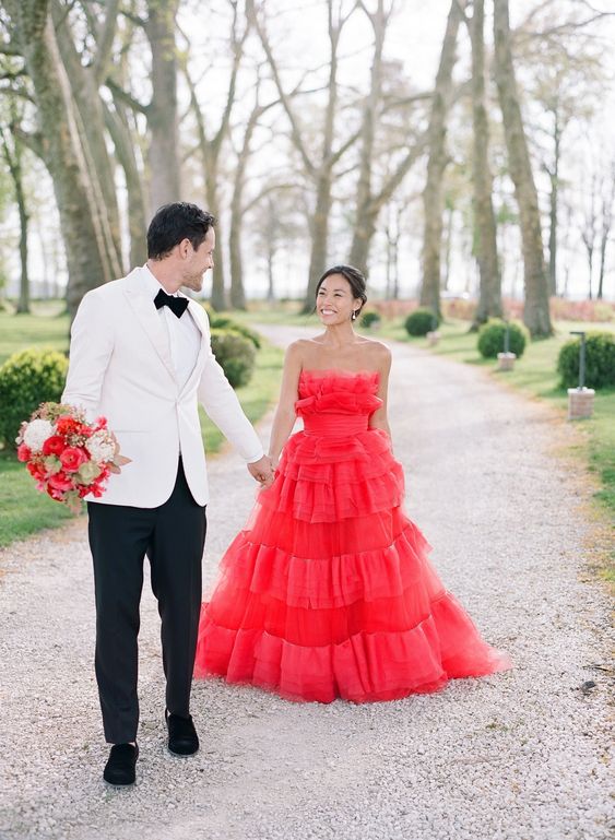 a jaw dropping hot red strapless wedding ballgown with lots of ruffles is a fantastic way to make a statement and the dress is very trendy due to lots of ruffles