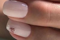 a light pink wedding manicure with a pink glitter heart and a pink glitter nail is a lovely idea to try