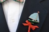 a mini boat with a red bow wedding boutonniere is a lovely idea for those who are tying the knot on the coast