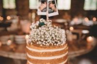 a naked wedding cake topped with baby’s breath and with Polaroids of the couple is a simple and lovely idea