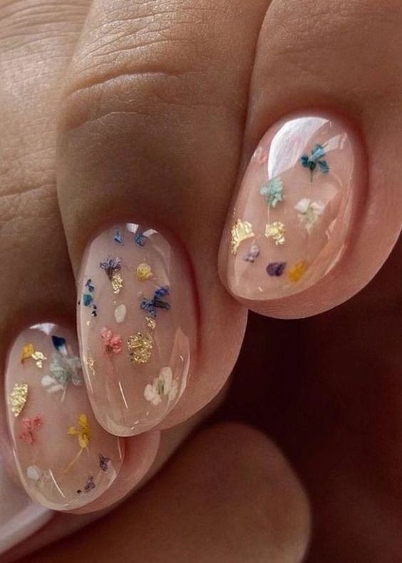 a nude wedding manicure with colorful dried blooms and gold foil is a catchy and pretty idea for a boho wedding