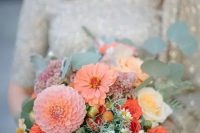 a peach and coral wedding bouquet with dahlias, roses and muted greenery is a lovely idea for a summer wedding with orange and peachy tones