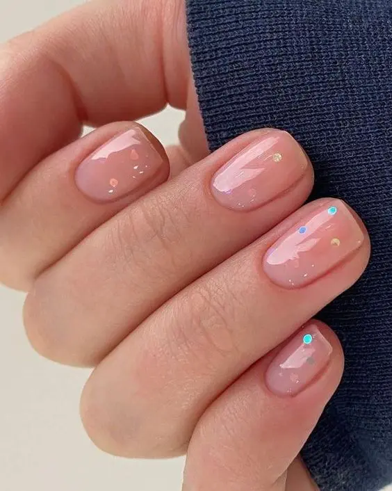 a simple and fun nude wedding manicure with colorful polka dots and a bit of glitter is a cool idea for a summer wedding
