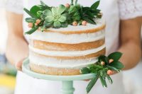 a simple naked cake topped with succulents, berries and greenery for a modern rustic wedding